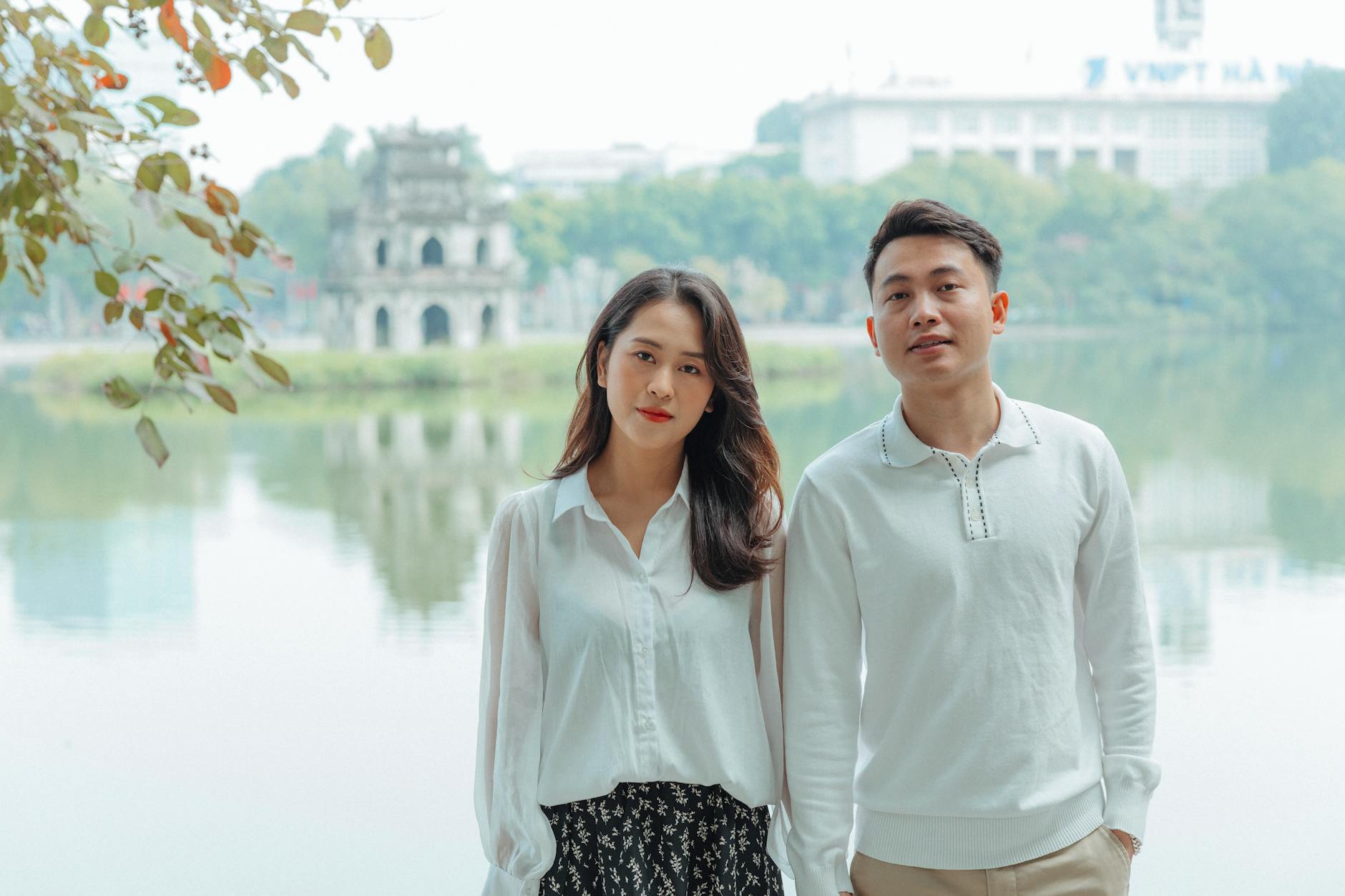 Asian couple enjoying a romantic moment by Hoan Kiem Lake in Hanoi
