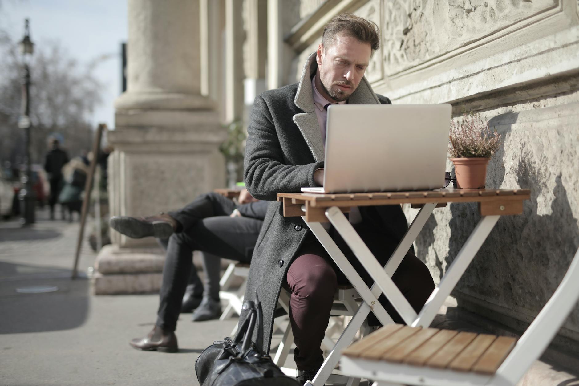 Hanoi Digital Nomad Guide 2026: Visas, Coworking, Wi-Fi & Costs 5 Freelancer working on laptop outdoors in urban area embracing remote work