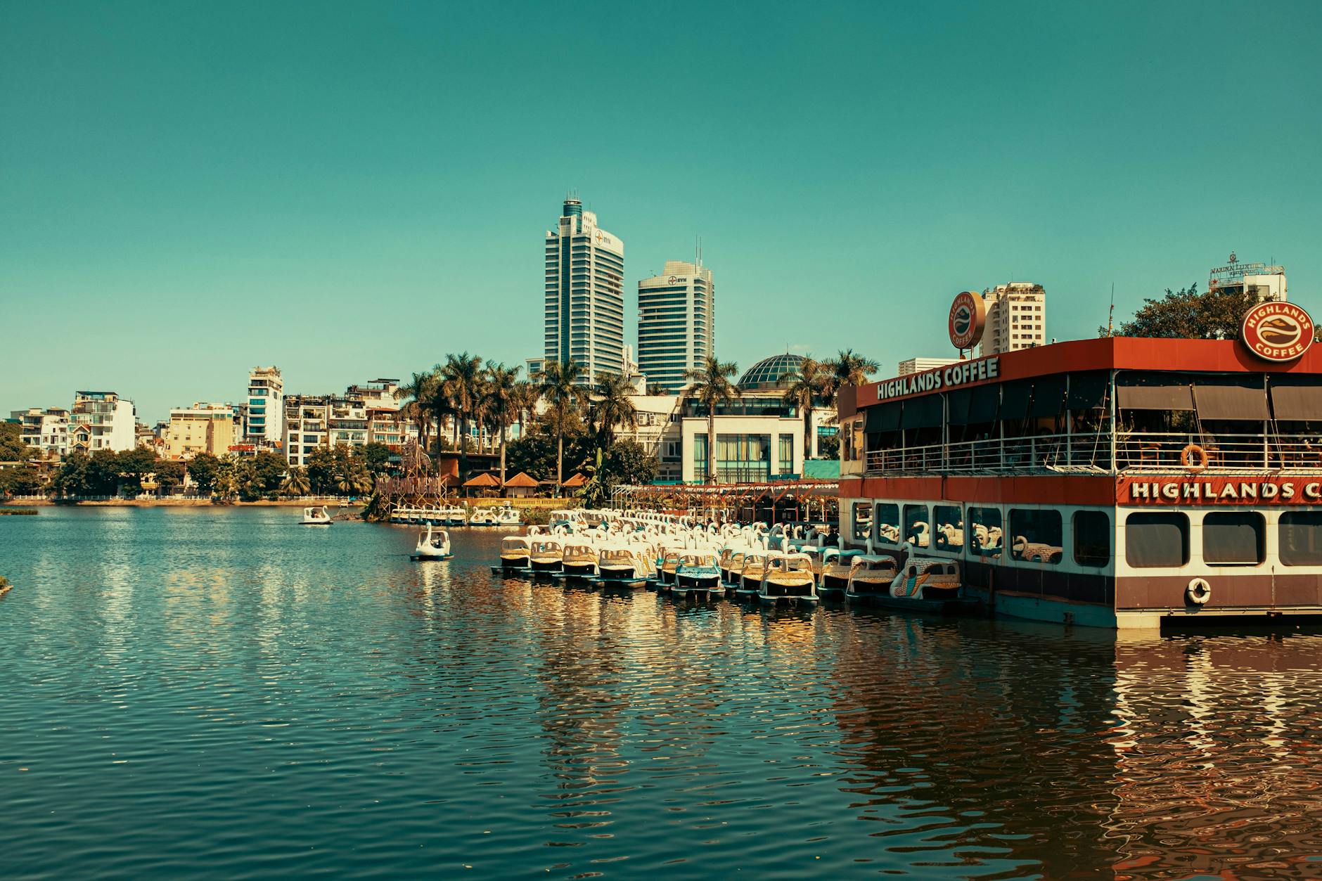 Hanoi Digital Nomad Guide 2026: Visas, Coworking, Wi-Fi & Costs 3 Vibrant Hanoi cityscape featuring skyscrapers, river, and a floating cafe