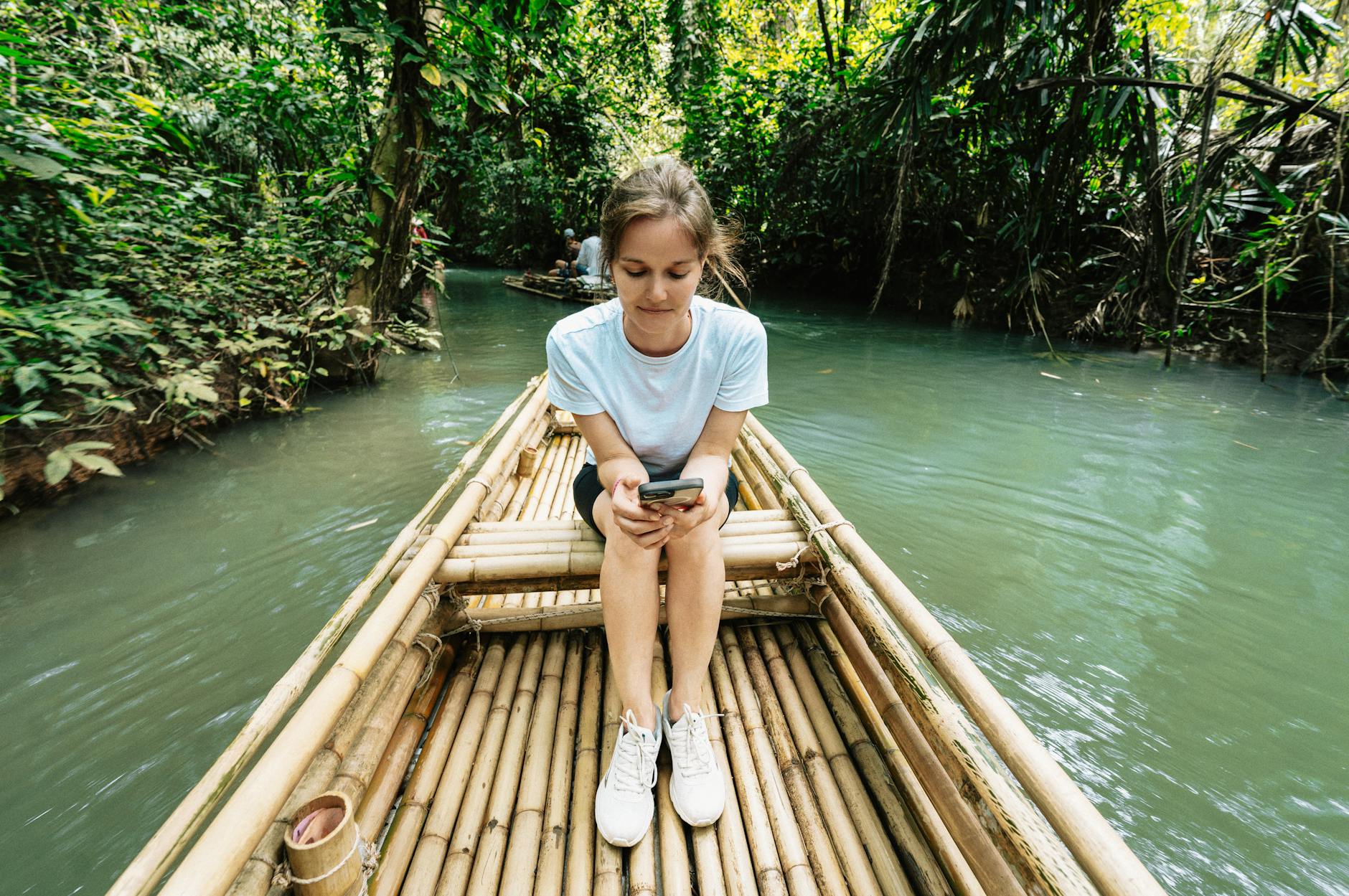 Hanoi for Solo Travelers: Complete Safety, Hostel & Activity Guide (2026) 5 Solo female traveler using her phone in nature