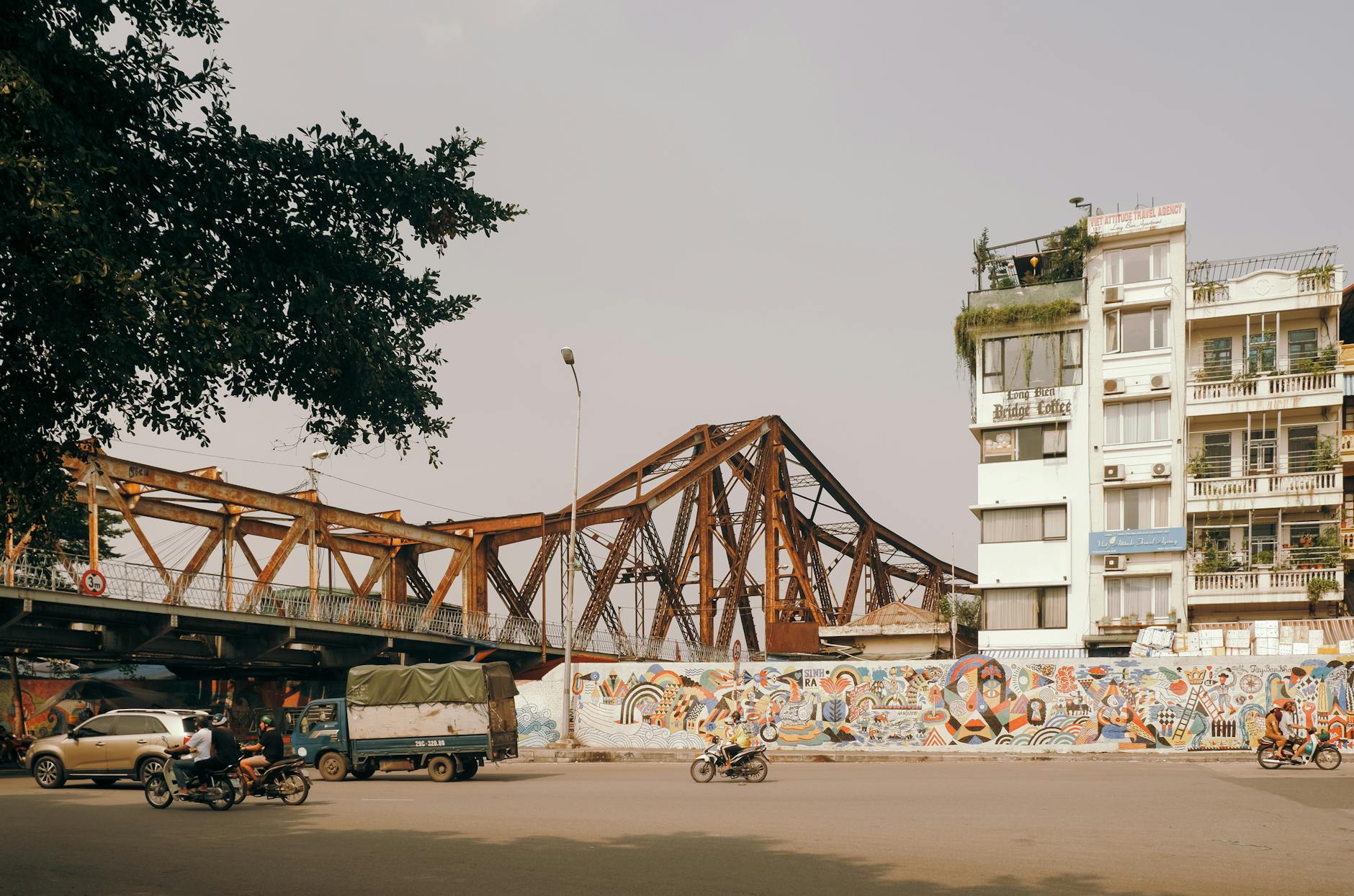 Vibrant street mural with Long Bien Bridge and Hanoi cityscape