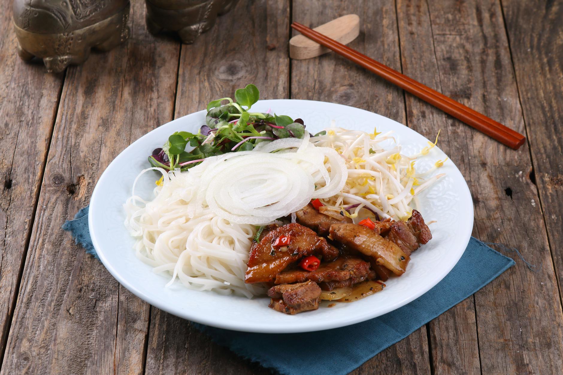 Traditional Vietnamese dish of grilled pork rice noodles and fresh vegetables