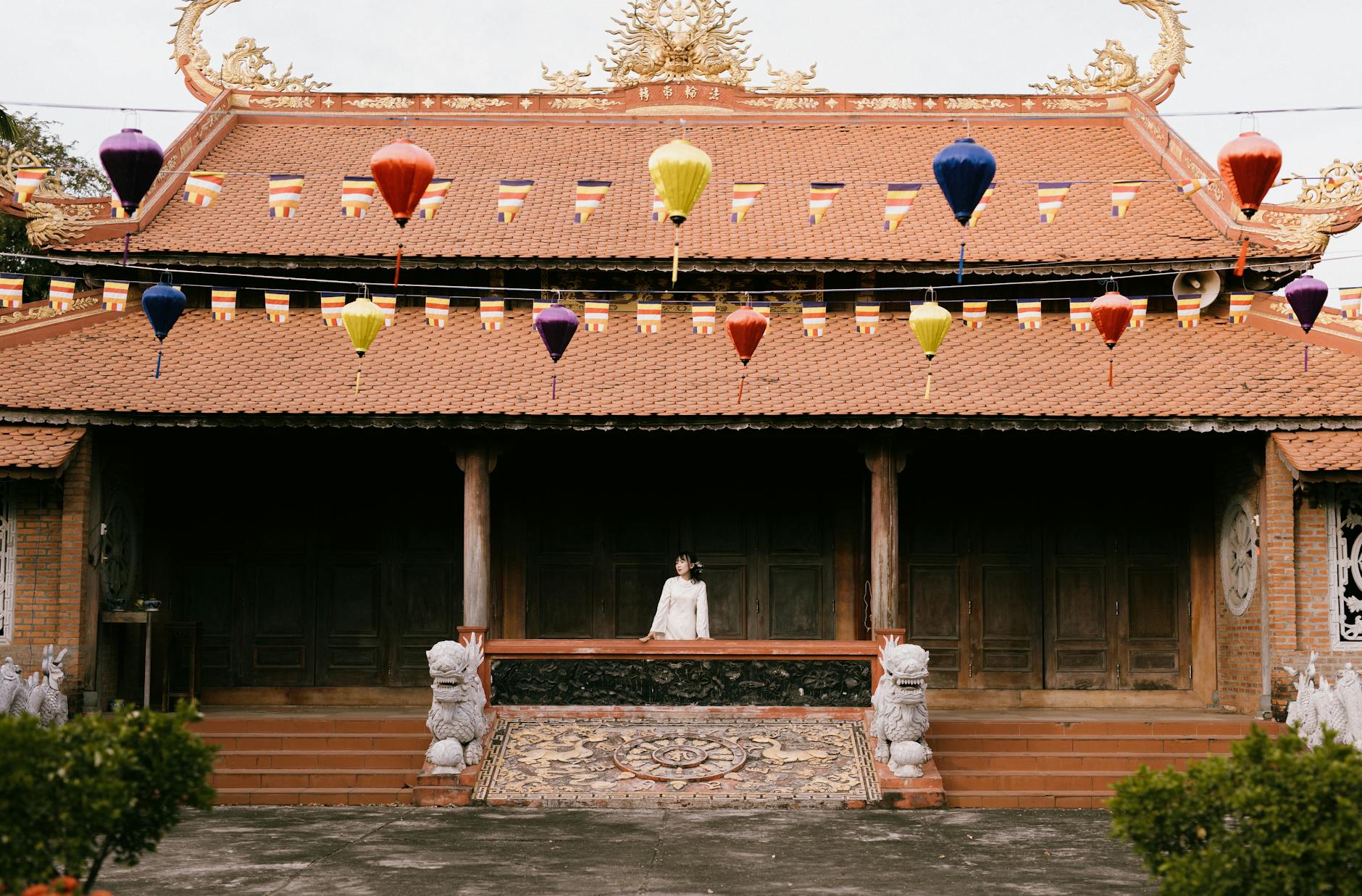 Cultural Experiences in Hanoi: 30+ Art, Crafts & Traditions (2026) 2 Traditional Asian building adorned with colorful lanterns and flags
