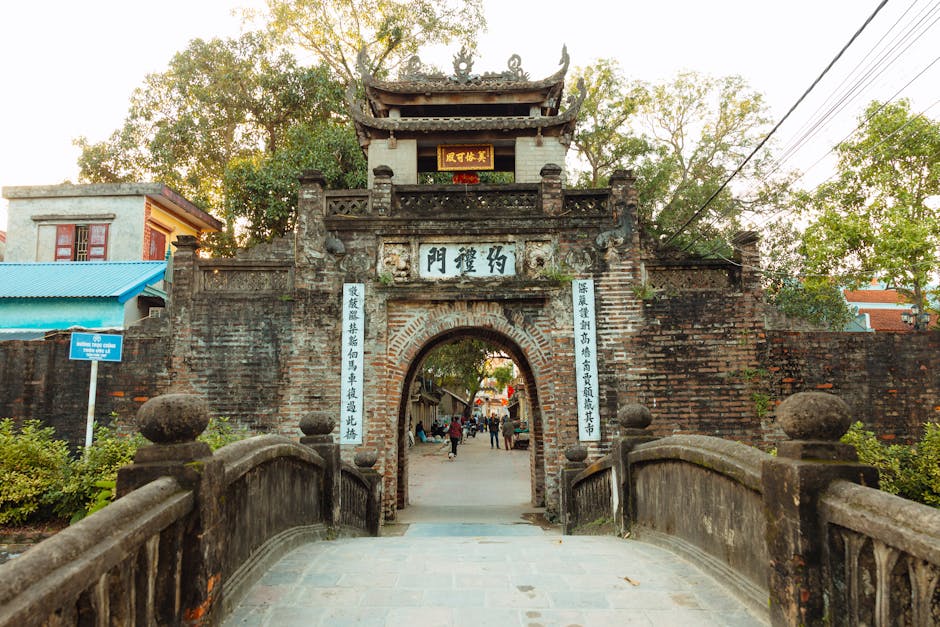 Duong Lam Ancient Village: Hanoi's Best Heritage Day Trip (2026) 1 Traditional stone gate entrance to ancient Vietnamese village