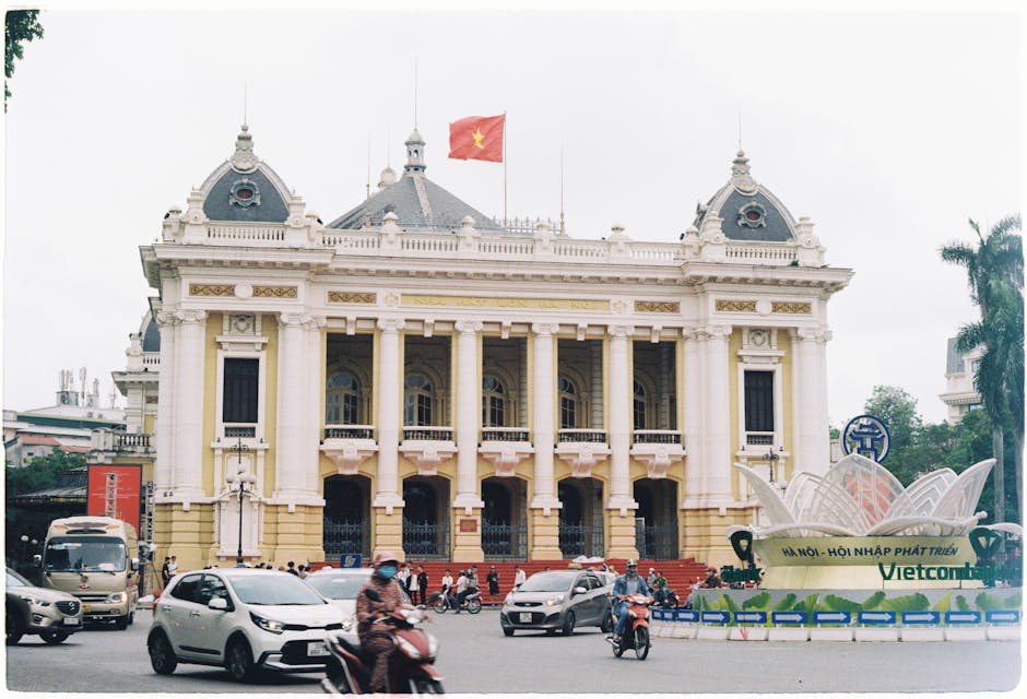 French Colonial Architecture Hanoi: Historic Buildings (2026) 2 Hanoi Opera House with Vietnamese flag and traffic