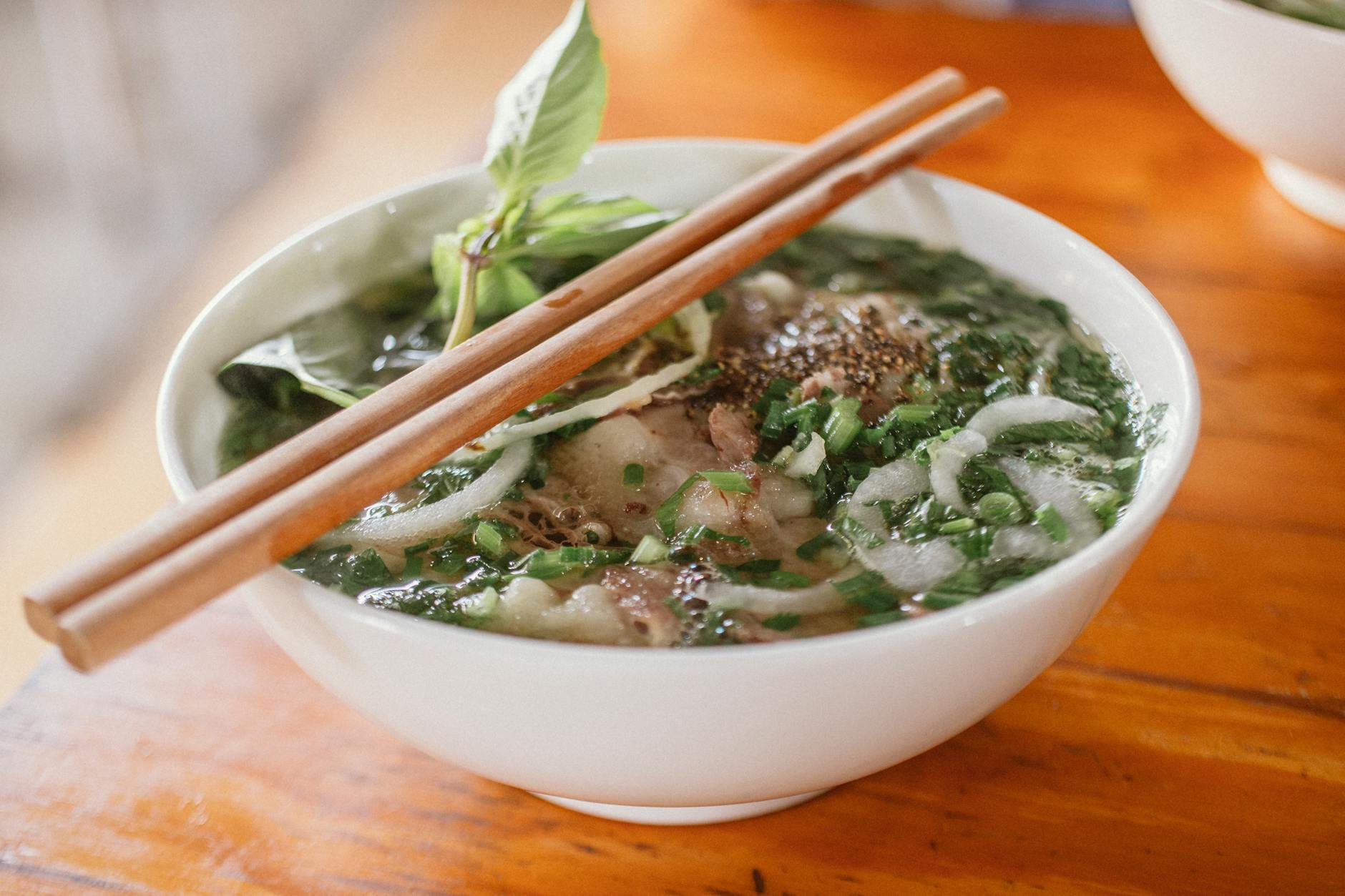 Hanoi Cooking Classes: 10 Best Vietnamese Cuisine Schools (2026) 5 Bowl of Vietnamese pho with herbs and beef
