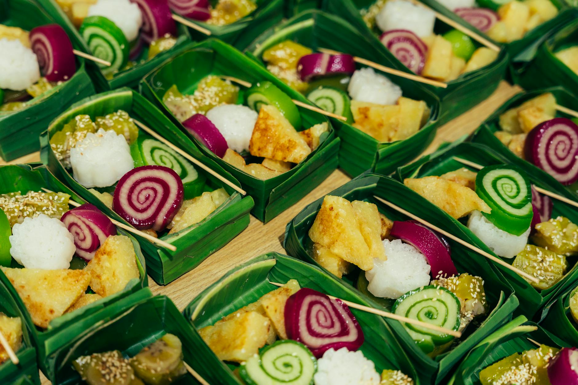 Hanoi Desserts & Sweets: 20 Best Treats & Cafes (2026) 1 Colorful Vietnamese sweets in banana leaf trays