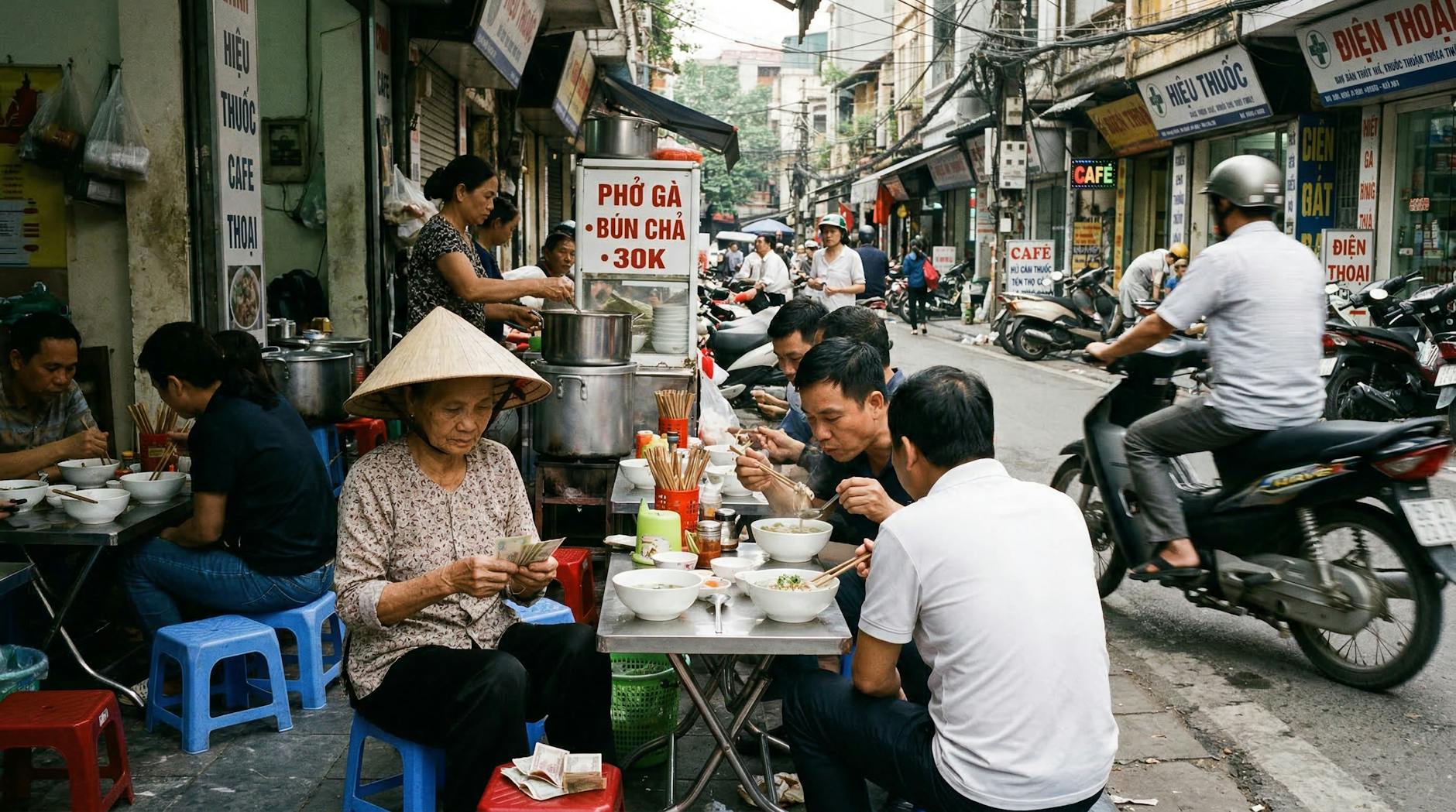 Hanoi Food Tours: 12 Best Guided Eating Experiences (2026) 2 Vibrant Old Quarter street food scene with locals enjoying Vietnamese cuisine