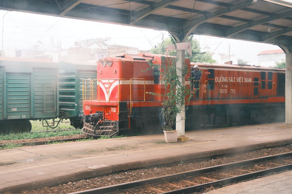 Red train parked at Vietnamese urban station