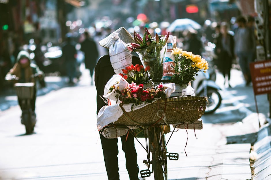 Hanoi in Spring: Weather, Flowers & Travel Tips (2026) 4 Vendor on bicycle selling flowers in Hanoi