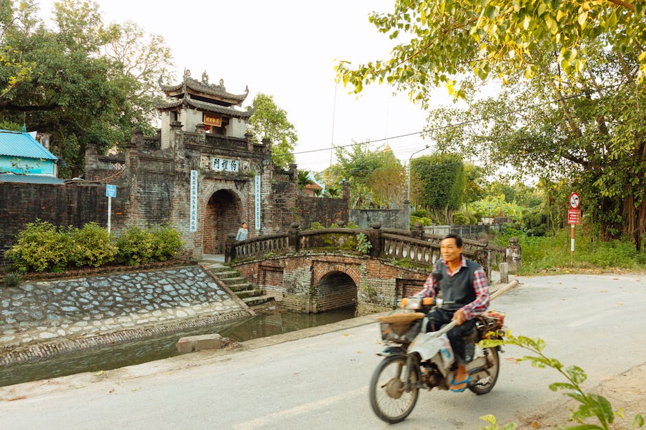 Imperial Citadel Thang Long: Fortress & History (2026) 3 Motorcyclist passing historic gate in Vietnam