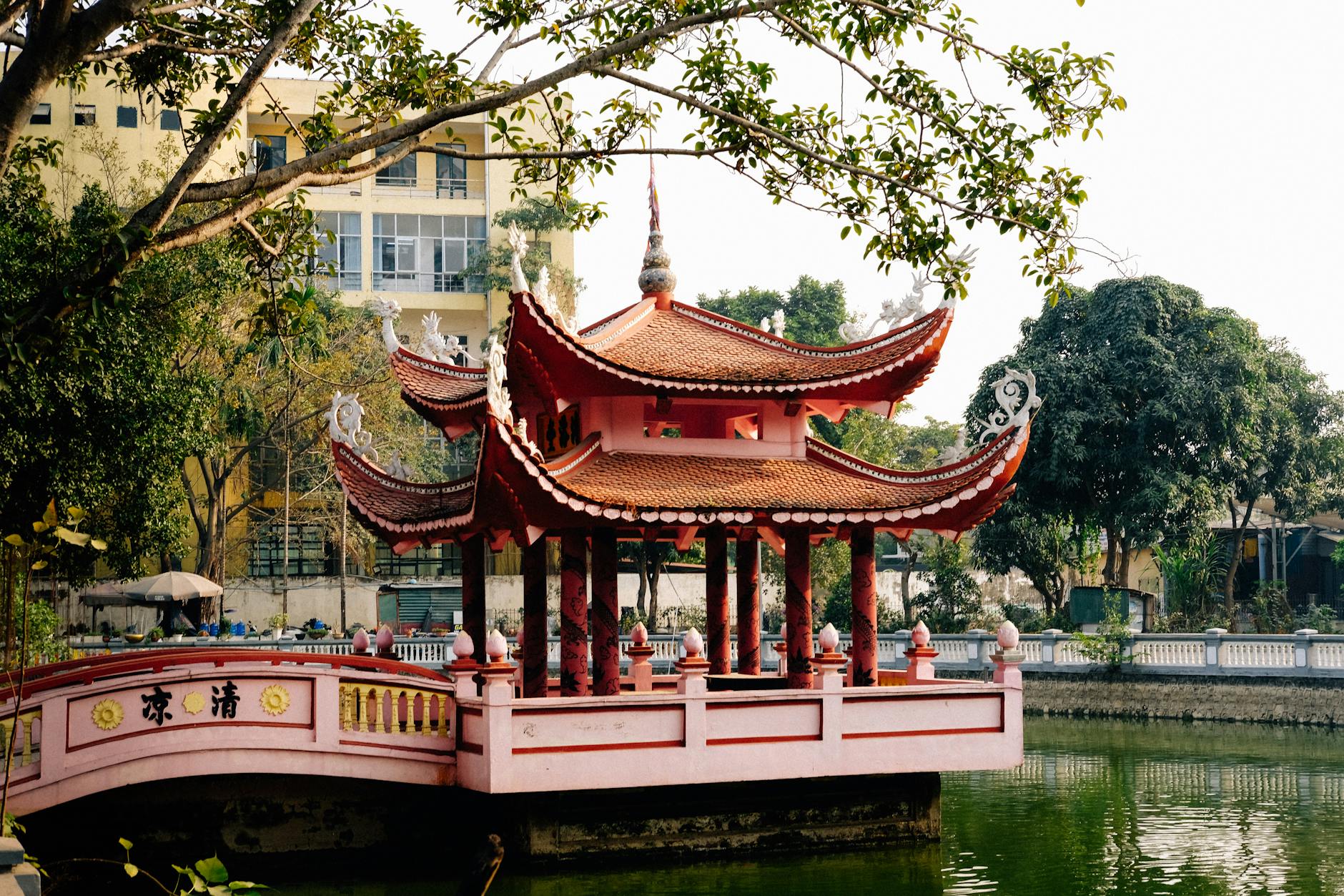 Ninh Binh Day Trip from Hanoi: Complete Guide (2026) 4 Beautiful traditional Vietnamese pagoda by a tranquil pond