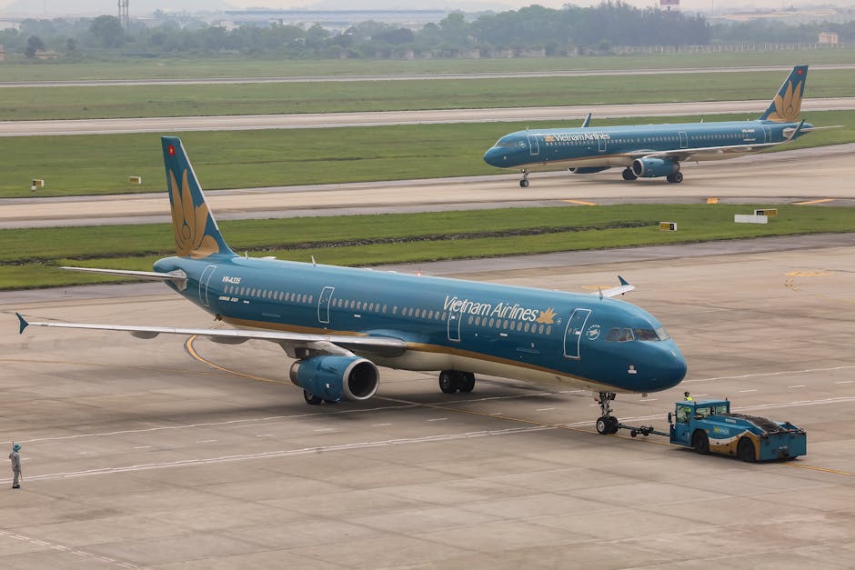 Hanoi Airport to City: Transport Options & Costs (2026) 2 Vietnam Airlines planes on Hanoi airport tarmac
