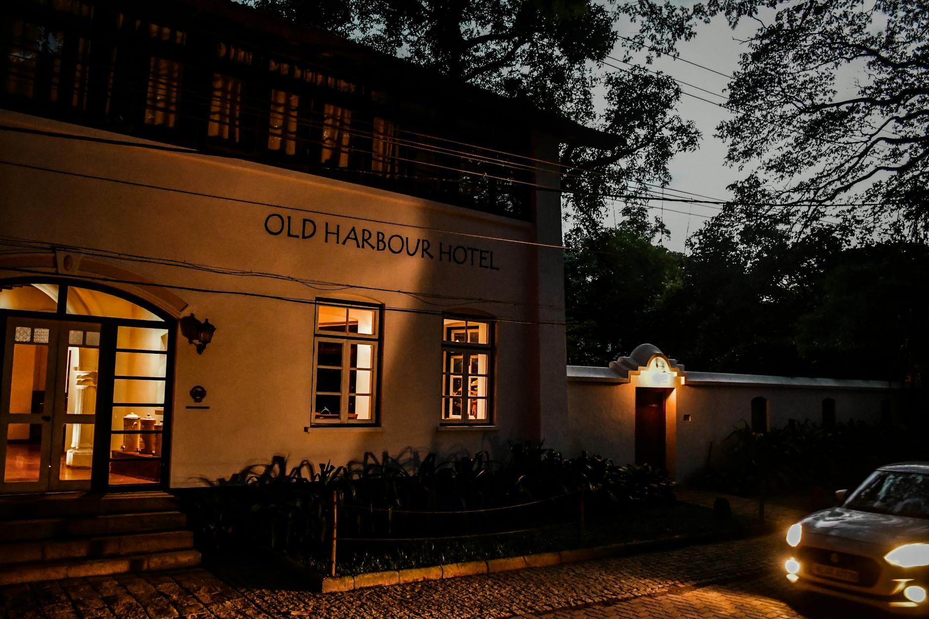 Old Quarter Architecture Hanoi: Colonial & Tube Houses (2026) 1 Heritage hotel illuminated at dusk with vintage charm and intricate architecture