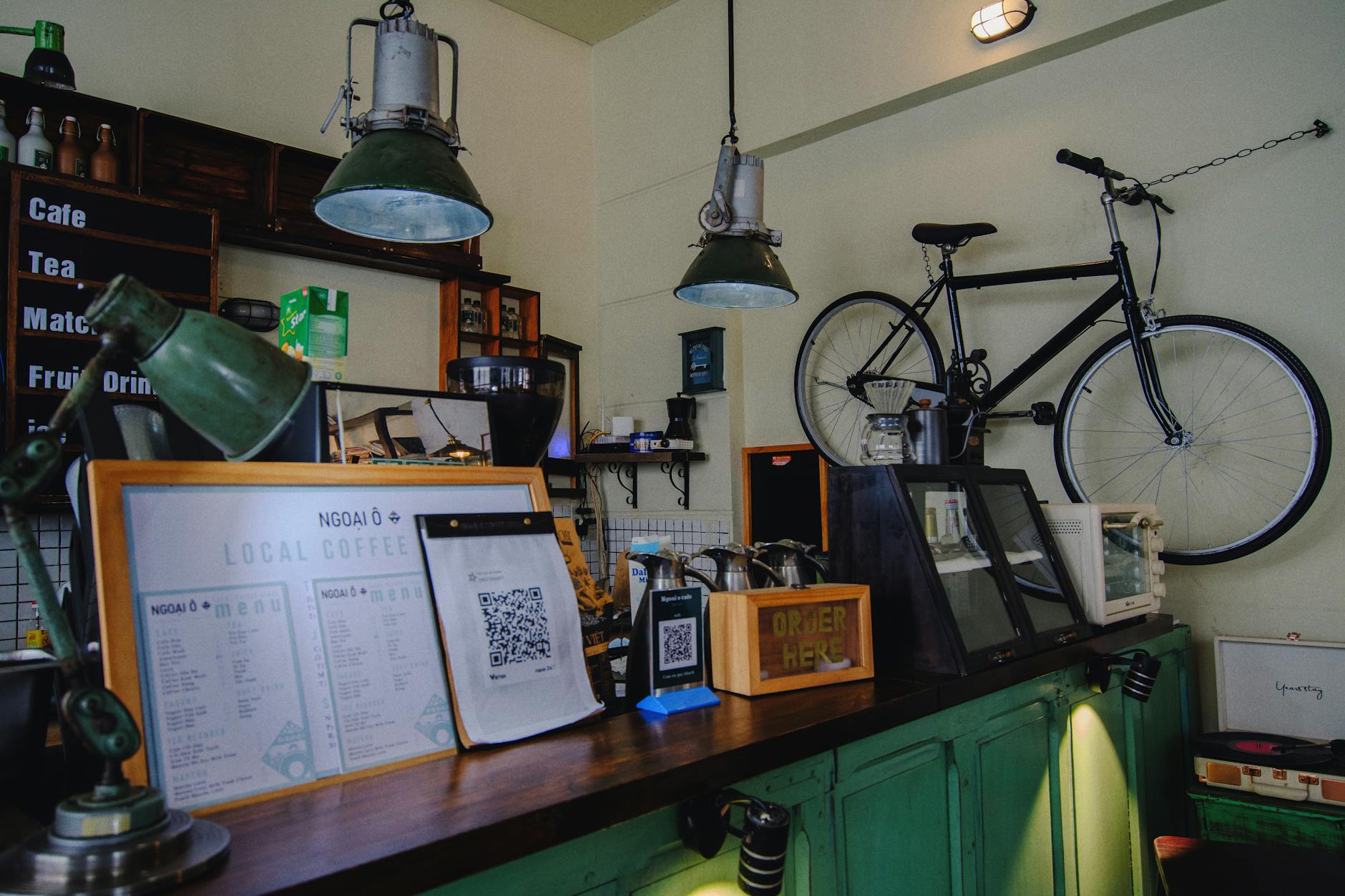 Best Cafes in Hanoi Old Quarter: 12 Coffee & Culture Spots (2026) 4 Inviting local coffee shop with vintage decor and suspended bicycle