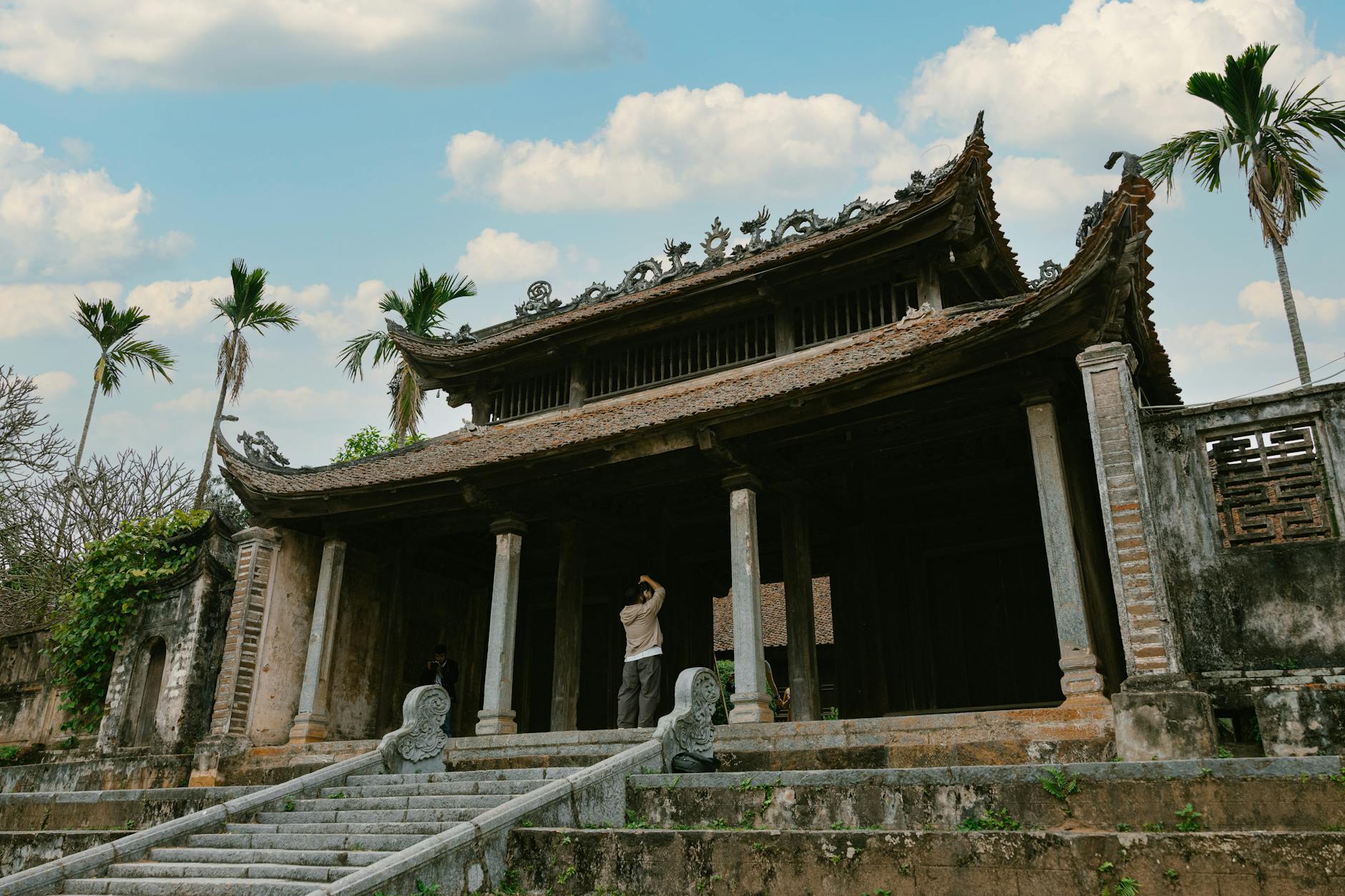 Beautiful Vietnamese temple with intricate architecture and palm trees