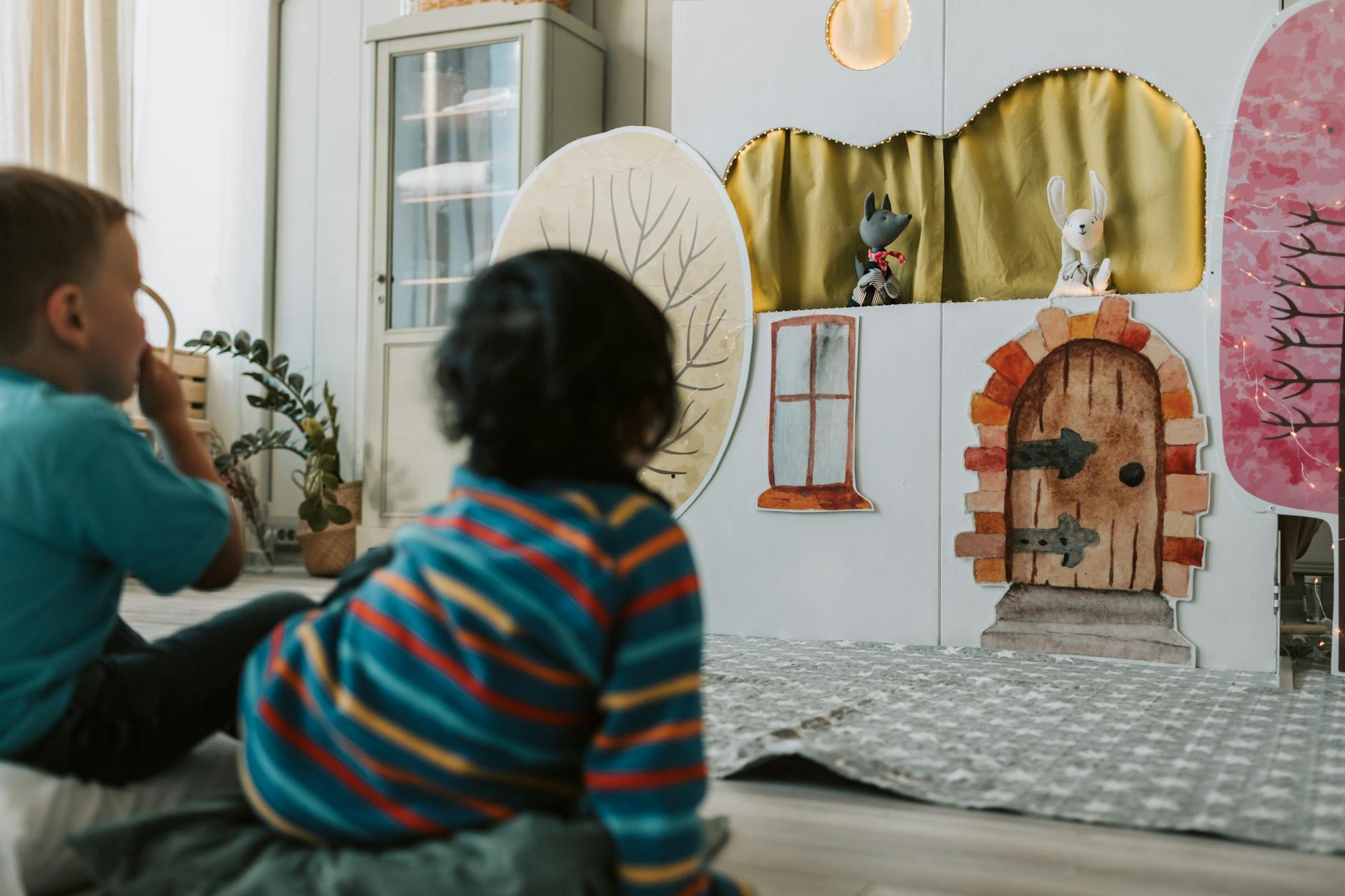 Children engaged and fascinated watching a puppet theater show